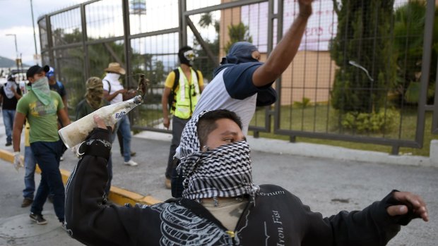 Students from the Ayotzinapa school take part in a protest demanding for justice.