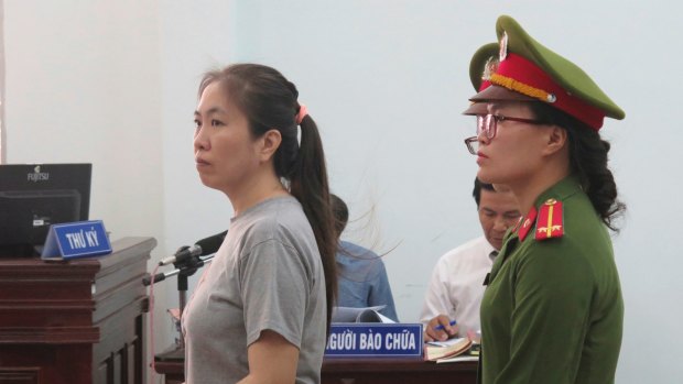 Prominent blogger Nguyen Ngoc Nhu Quynh, left, stands trial in Vietnam in June.