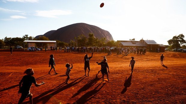 Children playing footy during the closing ceremony in the Mutitjulu community of the First Nations Convention in Uluru.