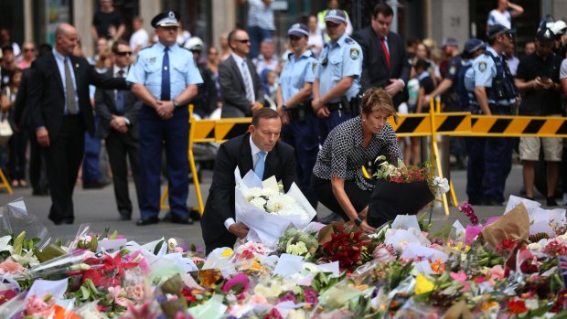 Prime Minister Tony Abbott and wife Margaret lay bouquets at Martin Place in Sydney on Tuesday. 