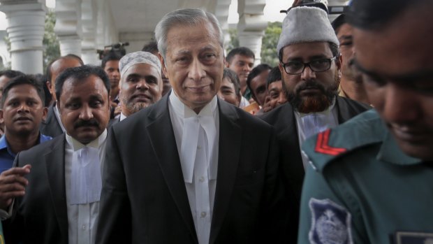Bangladesh's Attorney-General Mahbubey Alam, centre, walks out of the Supreme Court after the death sentences given to two influential opposition leaders for 1971 war crimes was upheld in Dhaka, Bangladesh, on November 18. 