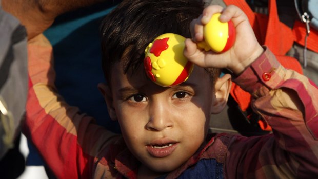 A Syrian refugee boy with a rattle in his hand at a transit camp for refugees in Macedonia on Saturday.
