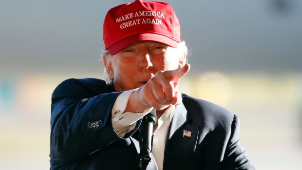 Red hot rage: Republican presidential candidate Donald Trump points to the media as he addresses the crowd during a campaign stop at the Minneapolis International Airport on Sunday.