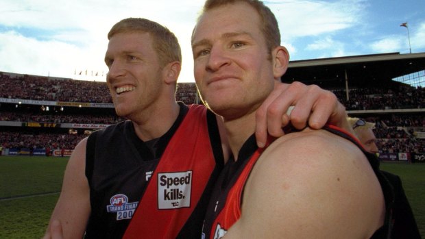 Dustin Fletcher and Sean Wellman celebrate victory in the 2000 grand final over Melbourne.