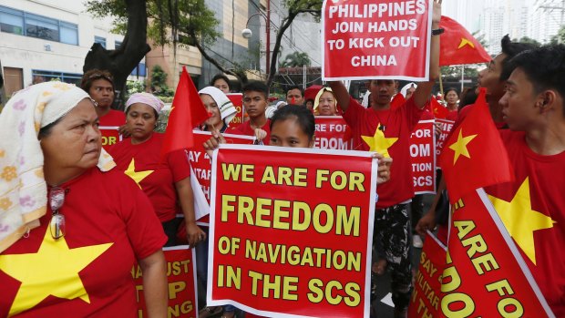 Filipinos, with Vietnamese expatriates, rally at the Chinese Consulate to protest against China's island-building and deployment of a missile system in the South China Sea on Thursday.