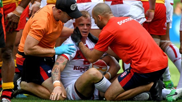 History of head knocks: Kevin Brown is treated by team medics after a heavy tackle against Papua New Guinea.