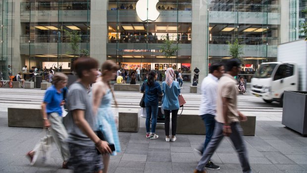 Shoppers stream past the Apple store in Sydney's George Street. 