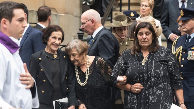 Marie Bashir stands with her family after the funeral service for her husband Sir Nicholas Shehadie.