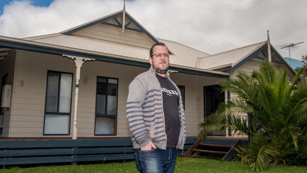 Joel Rudd, director of Phillip Island Holiday Homes, stands outside one of his holiday rentals.