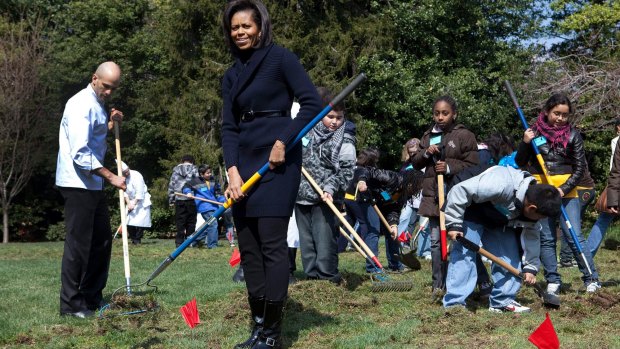 Michelle Obama and primary school students take part in groundbreaking of the White House Kitchen Garden in 2009.