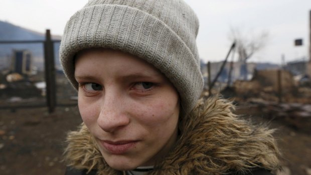 Local resident Rita Chernyshova stands amidst the debris of her burnt house in the settlement of Shyra, Russia after wildfires raged through it. 