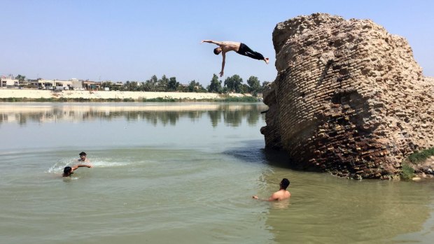 Iraqis jump off the ruins of an old building into the Tigris River to beat the heat in Baghdad this month. The temperature in Baghdad reached 47 degrees.
