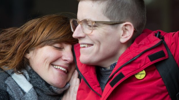 Roz Ward is hugged by a supporter on her return to work at La Trobe University in June. 