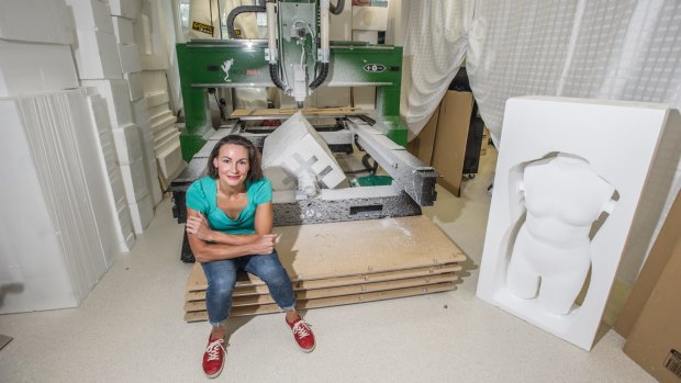Entrepreneur Hollie Bell with her CNC machine and one of her torsos.