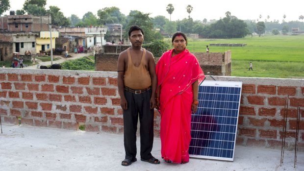 Farmer Satish Paswan, 35, and his wife farmer who sold some land to purchase a solar panel and light so their five children could do their homework.