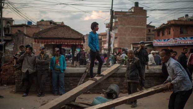 Earthquake survivors block a street as they protest the lack of help from the government in Kathmandua.