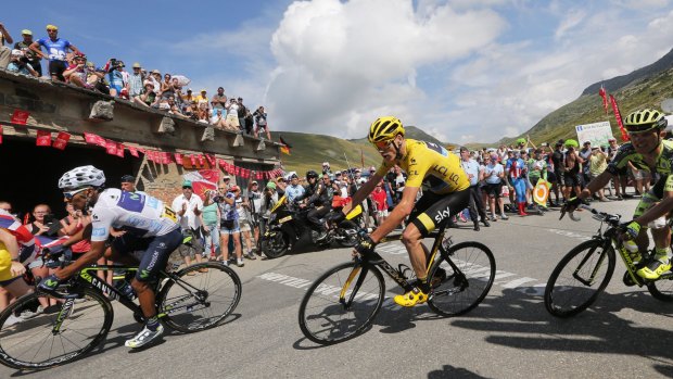Colombia's Nairo Quintana and Britain's Chris Froome, wearing the overall leader's yellow jersey climb Glandon pass during the eighteenth stage of the Tour de France.
