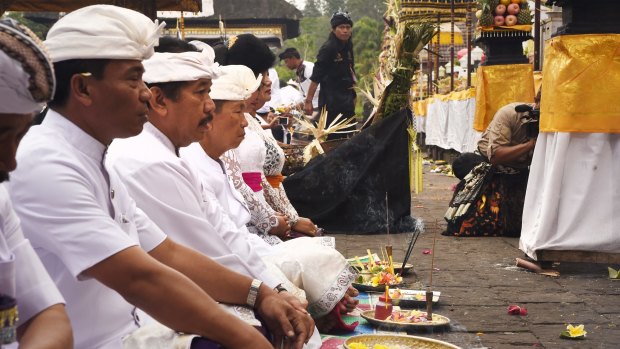 Balinese Governor I Made Mangku Pastika (fourth from left, front row) prays at Besakih temple.