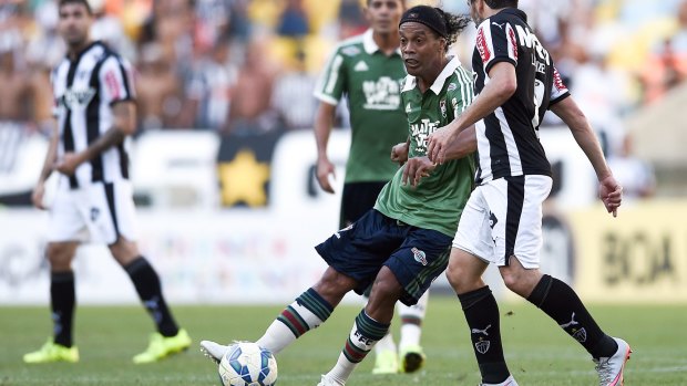 Veteran star: Ronaldinho controls the ball during a match for Fluminense against Atletico Mineiro in the Brasileirao Series A last August.