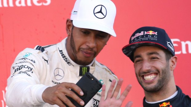 Capture the moment: Mercedes driver Lewis Hamilton of Britain (left), with Red Bull driver Daniel Ricciardo, after winning the Japanese Formula One Grand Prix at Suzuka.