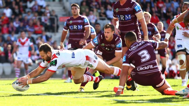 Coming through: Jason Nightingale carves through the Manly defence to score.