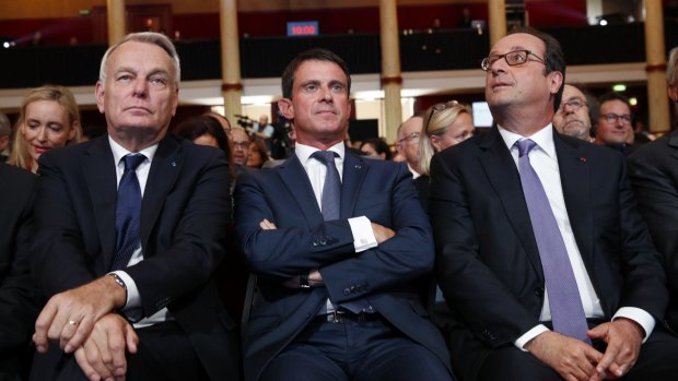 French Prime Minister Manuel Valls, centre, with French President Francois Hollande, right, and French Foreign Minister Jean-Marc Ayrault. 