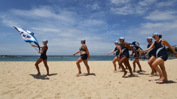 Coogee Surf Club members brave the heat to compete in the march past at the Surf Life Saving Carnival at Coogee Beach.