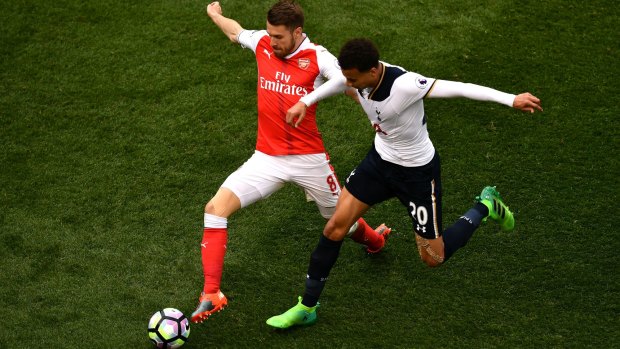 Arsenal's Aaron Ramsey and Tottenham's Dele Alli battle for possession.