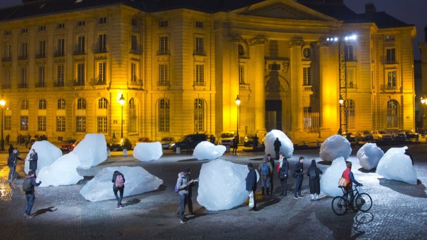 Visitors walk through ice blocks as part of the sculpture Ice Watch, by Danish artist Olafur Eliasson, as part of the Paris climate talks. 