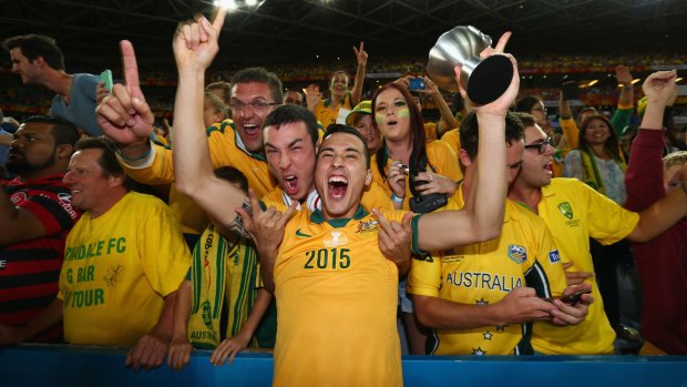 Jason Davidson of Australia celebrates with fans after Australia defeated South Korea in the 2015 Asian Cup final.