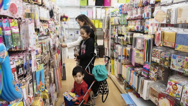 The Choy family browse products at Daiso's new store in Lidcombe.
