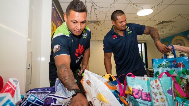 Raiders players Josh Papalii and Joey Leilua choosing show bags for children at the Canberra Hospital.