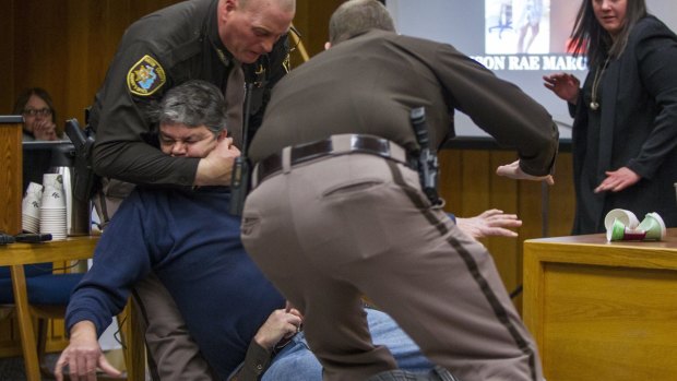 Sheriff's deputies restrain Randall Margraves in a Michigan court room after he tried to attack disgraced doctor Larry Nassar.