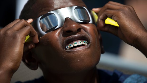 Children look after their eyes wearing glasses during the solar eclipse.