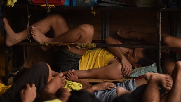 Some of the 3562 inmates sleep on any space they can find in a classroom in Quezon city jail, Philippines. 