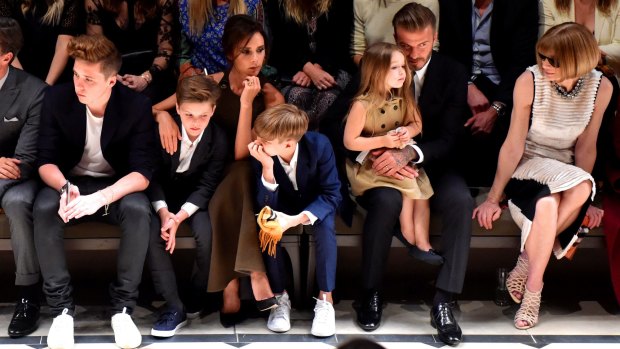 Front row: The Beckham clan by the Burberry catwalk, along with the editor-in-chief of American Vogue, Anna Wintour.