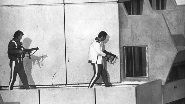 Two West German police armed with sub machine guns get into position on the roof of the Munich Olympic village.