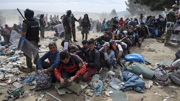 Refugees and migrants wait to cross the border from the northern Greek village of Idomeni to Macedonia at the height of the migrant crisis in 2015.