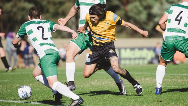 Cooma's Jeremias Ibarra, and Tuggeranong United's Mitch Steenbergen compete.
