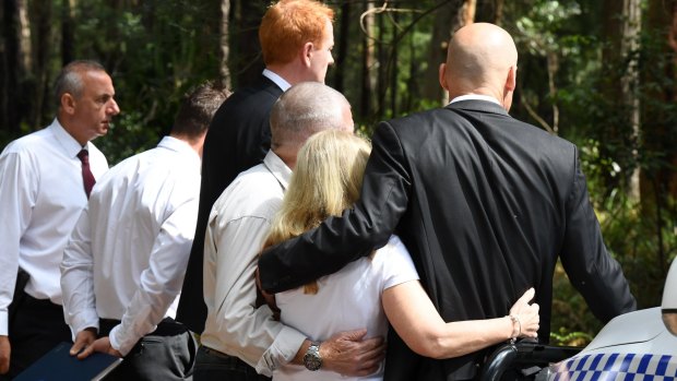 Faye and Mark Leveson (middle) embrace detectives at the search site last year.