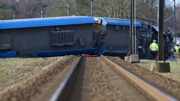 The derailed train lies across the rails near Dalfsen.