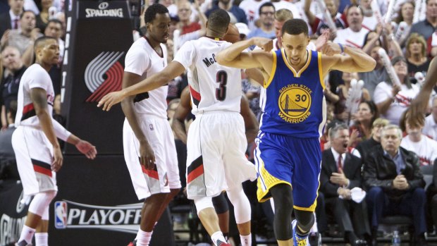 Golden State Warriors guard Stephen Curry reacts after scoring a basket against the Portland Trail Blazers on Monday.