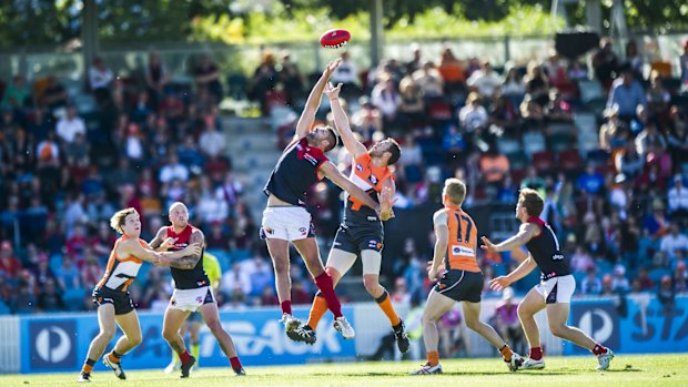 Melbourne's Mark Jamar and GWS' Shane Mumford jump for the ball. 