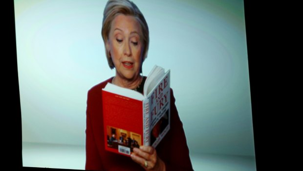 Hillary Clinton reads an excerpt from <i>Fire and Fury</i> during a skit at the annual Grammy Awards.
