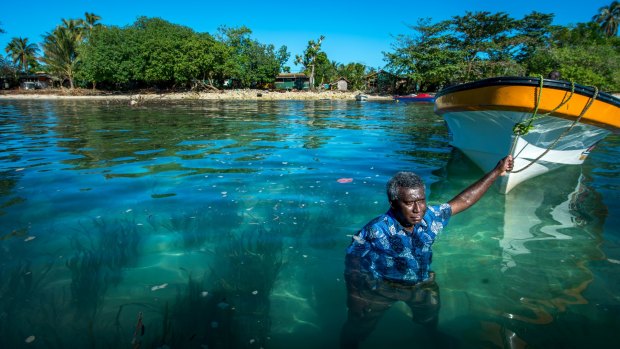 Jackson Kiloe, the Premier of Taro in the Solomon Islands, standing where the shoreline used to be. 