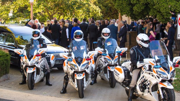 Sir Peter Lawler's cortege was escorted by police motorcyclists to the Woden cemetery.
