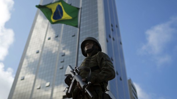 A soldier stands in guard at the Copacabana Beach ahead of the Rio Olympics.