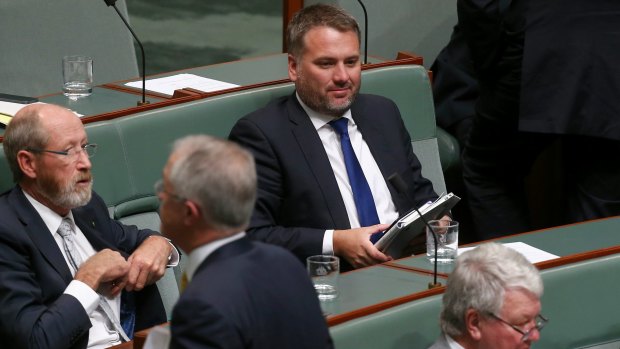 Prime Minister Malcolm Turnbull walks past Jamie Briggs at the end of question time.