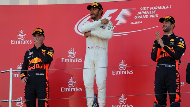 Lewis Hamilton, second placed Dutchman Max Verstappen, left, and teammate Daniel Ricciardo on the podium.