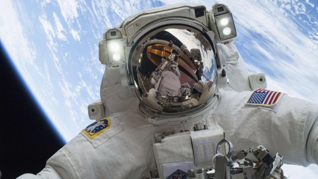 Running repairs: Astronaut Mike Hopkins on a spacewalk last year to replace a faulty water pump outside the International Space Station. 